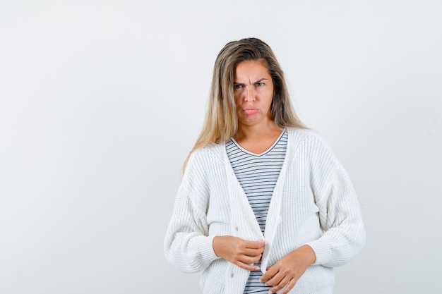 Free Photo portrait of beautiful woman looking at ?amera in jacket and looking unhappy front view