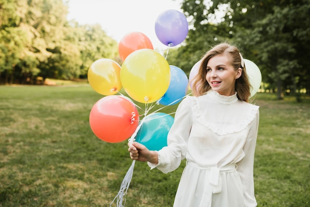 Portrait beautiful woman oudoors with ballons