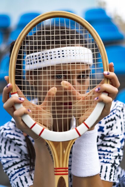 Portrait of beautiful woman playing tennis outdoor