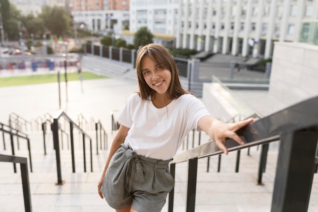 Free Photo portrait of a beautiful woman posing on stairs