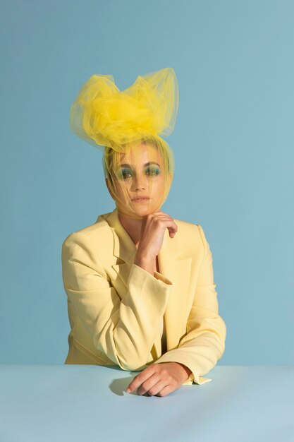 Portrait of beautiful woman posing with an avantgarde head piece