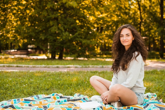 Portrait of a beautiful woman sitting on blanket