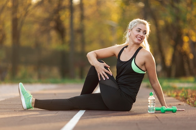 Portrait of beautiful woman sitting on ground