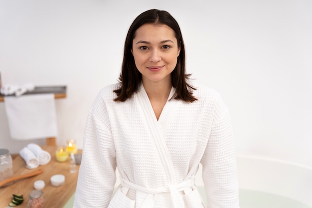 Portrait of a beautiful woman standing by the bathtub before taking a bath