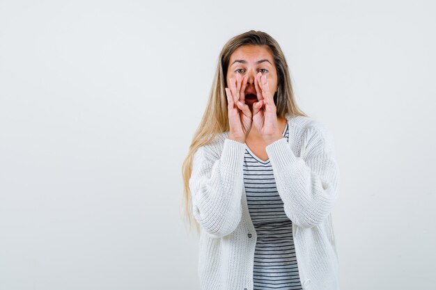 Portrait of beautiful woman telling a secret in jacket and looking mysterious front view