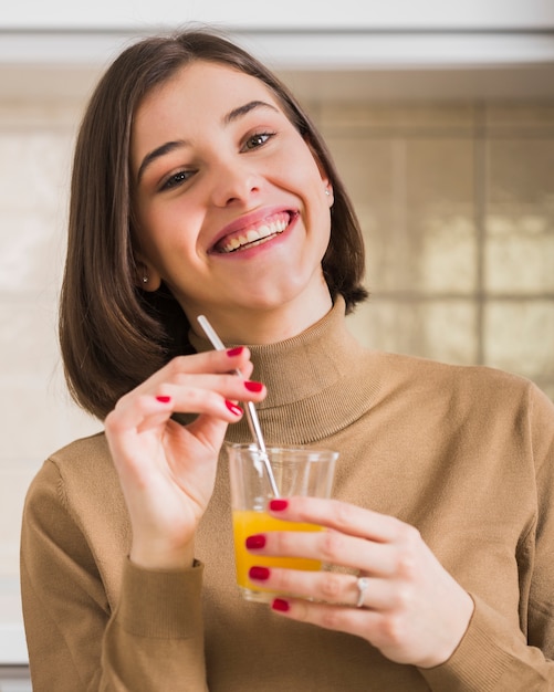 Free photo portrait of beautiful woman with orange juice