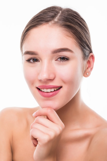 Portrait of a beautiful woman with perfect skin on white wall