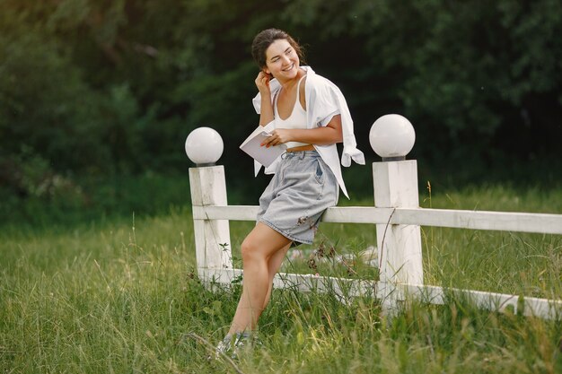 Portrait of beautiful woman. Woman read a book. Lady in a white shirt.