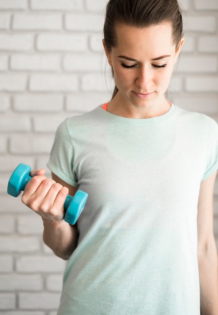 Portrait of beautiful woman working out at home