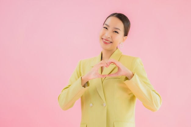 Portrait beautiful young asian business woman smile in action on pink color