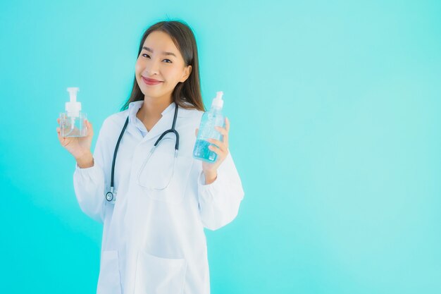 Portrait beautiful young asian doctor woman with gel alcohol for clean hand