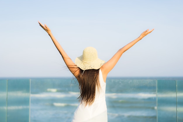 Portrait beautiful young asian woman happy and smile on the beach sea and ocean