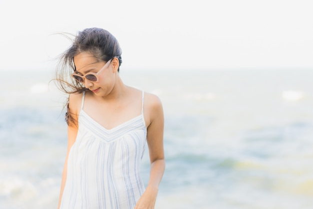 Portrait beautiful young asian woman happy smile relax around neary beach and sea