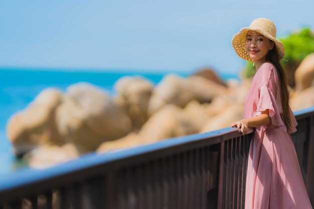 Portrait beautiful young asian woman looking sea beach ocean for relax in holiday vacation travel