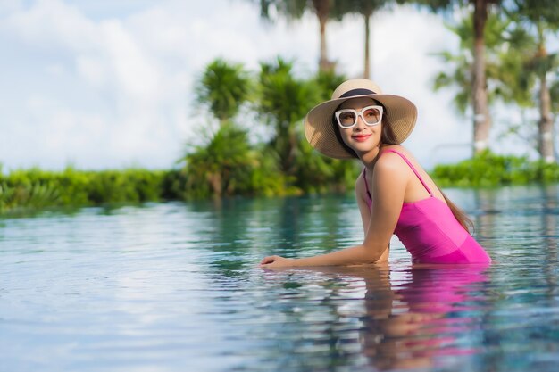 Portrait beautiful young asian woman relax enjoy around outdoor swimming pool in holiday vacation