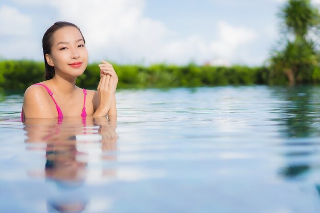 Portrait beautiful young asian woman relax enjoy around outdoor swimming pool in holiday vacation