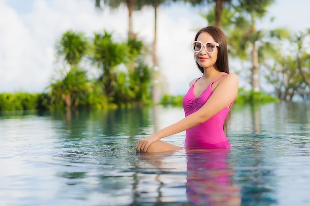 Portrait beautiful young asian woman relax enjoy around outdoor swimming pool in holiday vacation