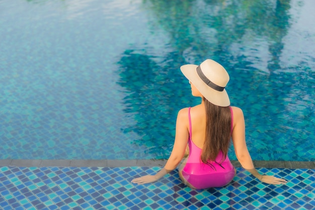 Portrait beautiful young asian woman relax enjoy around outdoor swimming pool in holiday vacation