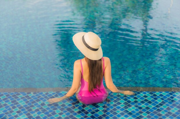 Portrait beautiful young asian woman relax enjoy around outdoor swimming pool in holiday vacation