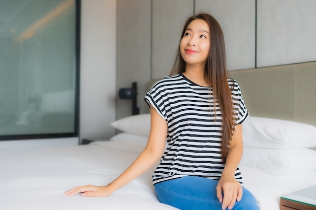 Portrait beautiful young asian woman relax happy smile in bedroom