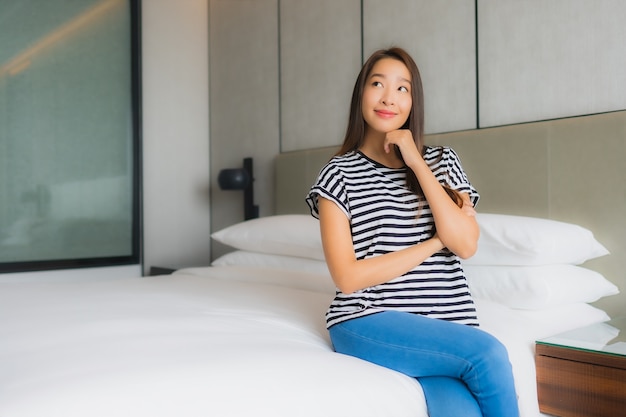 Portrait beautiful young asian woman relax happy smile in bedroom