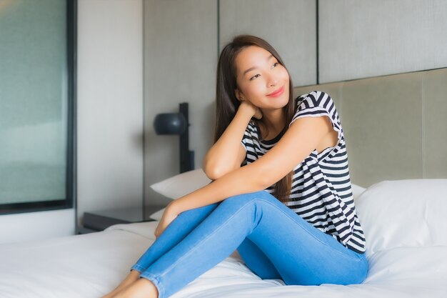 Portrait beautiful young asian woman relax happy smile in bedroom