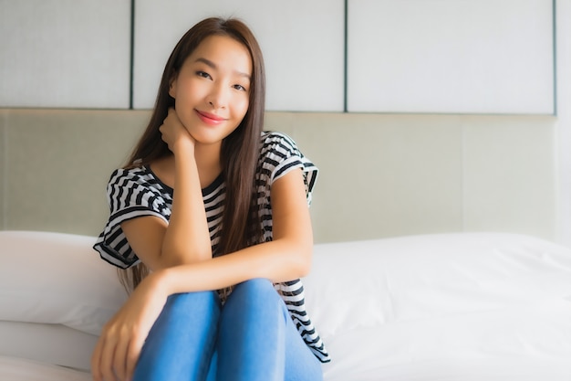 Portrait beautiful young asian woman relax happy smile in bedroom