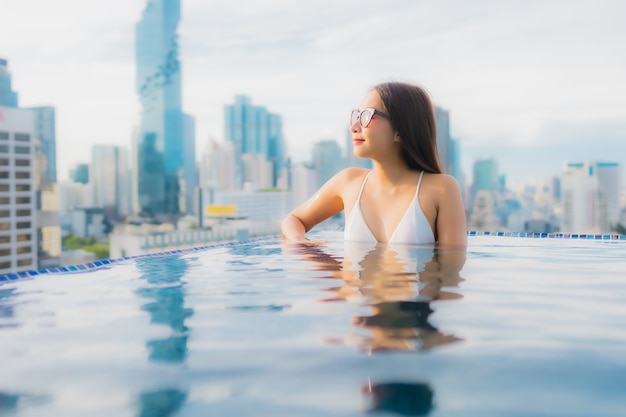 Free photo portrait beautiful young asian woman relax happy smile leisure around outdoor swimming pool