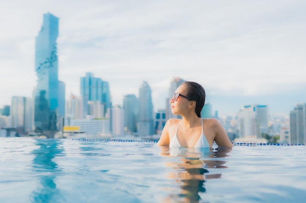 Free photo portrait beautiful young asian woman relax happy smile leisure around outdoor swimming pool