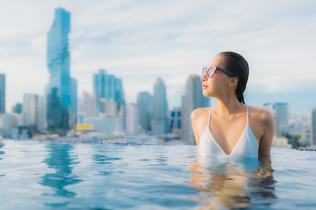 Free photo portrait beautiful young asian woman relax happy smile leisure around outdoor swimming pool