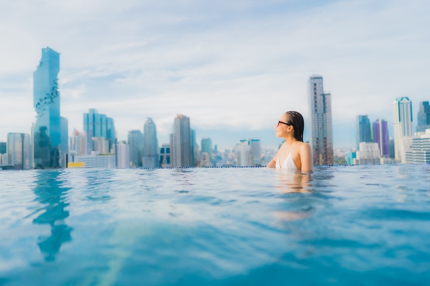 Portrait beautiful young asian woman relax happy smile leisure around outdoor swimming pool