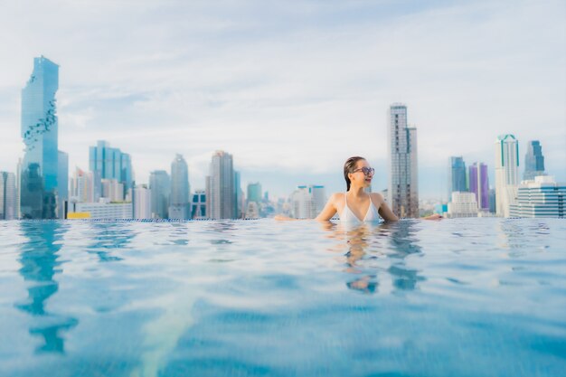 Portrait beautiful young asian woman relax happy smile leisure around outdoor swimming pool