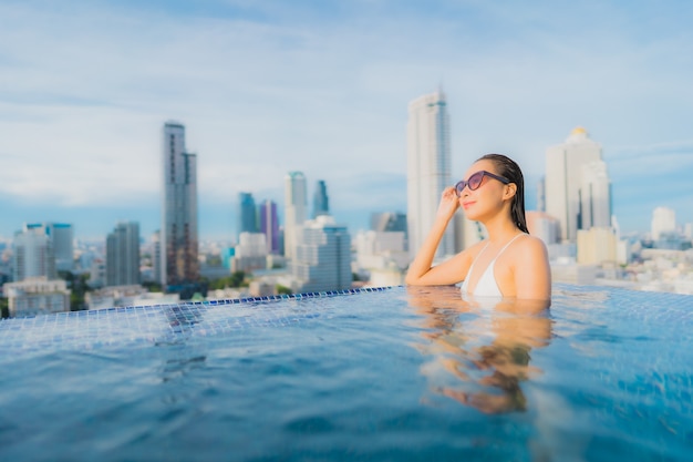 Portrait beautiful young asian woman relax happy smile leisure around outdoor swimming pool