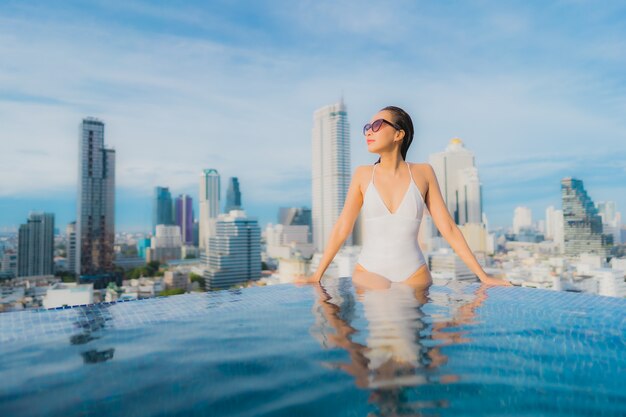 Portrait beautiful young asian woman relax happy smile leisure around outdoor swimming pool