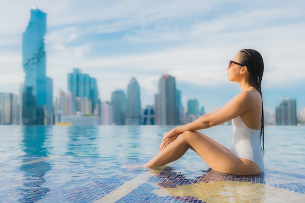 Portrait beautiful young asian woman relax happy smile leisure around outdoor swimming pool