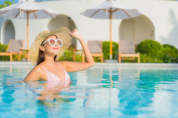 Portrait beautiful young asian woman relax leisure around outdoor swimming pool with sea