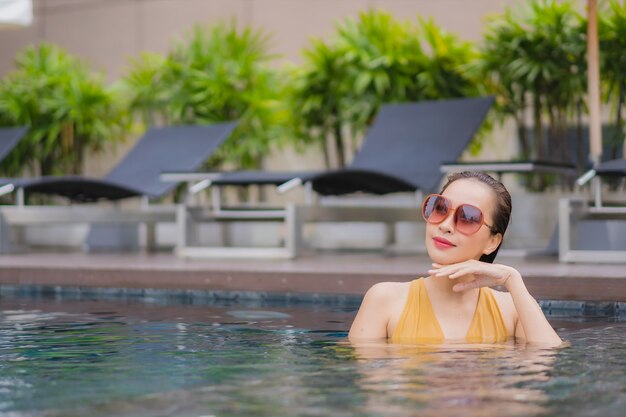 Portrait beautiful young asian woman relax leisure around swimming pool