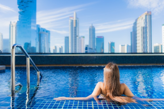 Free photo portrait beautiful young asian woman relax leisure enjoy around outdoor swimming pool