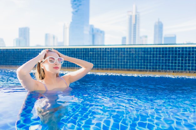 Free photo portrait beautiful young asian woman relax leisure enjoy around outdoor swimming pool