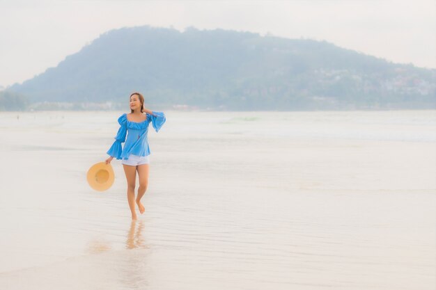 Portrait beautiful young asian woman relax leisure smile around beach sea ocean at sunset time