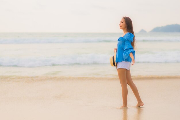 Portrait beautiful young asian woman relax leisure smile around beach sea ocean at sunset time