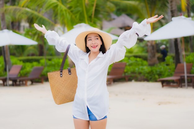 Portrait beautiful young asian woman relax smile around beach sea ocean in holiday vacation travel trip