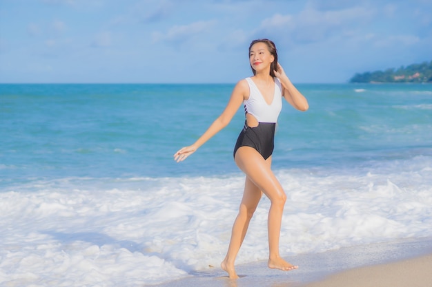 Portrait beautiful young asian woman relax smile around beach sea ocean in holiday vacation