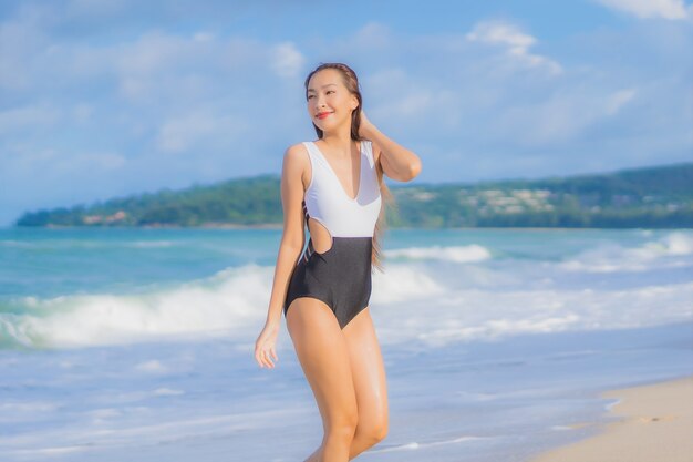 Portrait beautiful young asian woman relax smile around beach sea ocean in holiday vacation