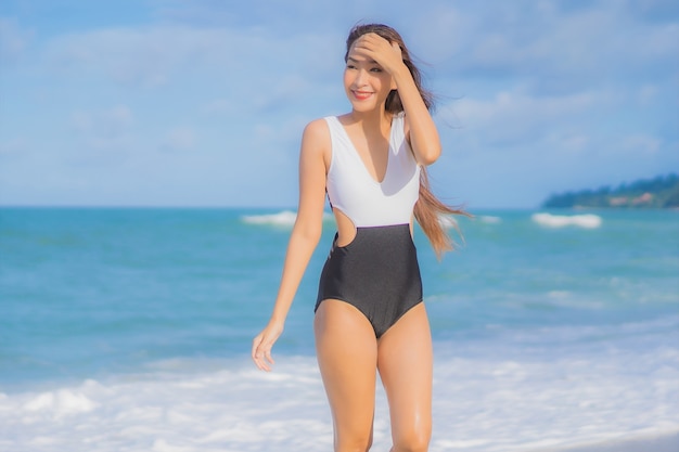 Portrait beautiful young asian woman relax smile around beach sea ocean in holiday vacation