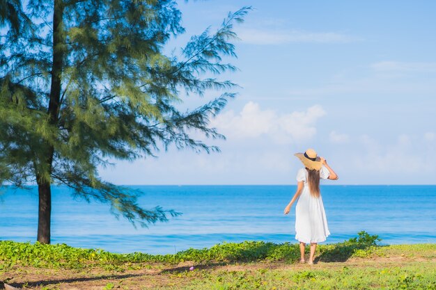 Portrait beautiful young asian woman relax smile around beach sea ocean with blue sky white cloud for travel vacation