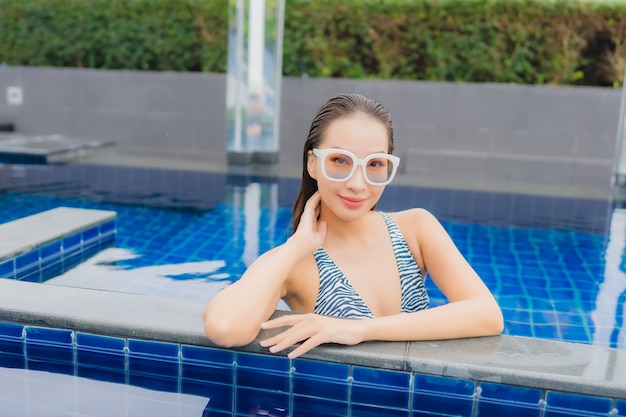 Portrait beautiful young asian woman relax smile around outdoor swimming pool