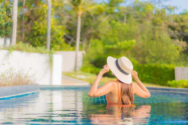 Portrait beautiful young asian woman relax smile leisure around outdoor swimming pool in hotel resort on travel vacation