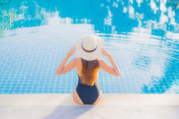 Portrait beautiful young asian woman relax smile leisure around outdoor swimming pool nearly sea