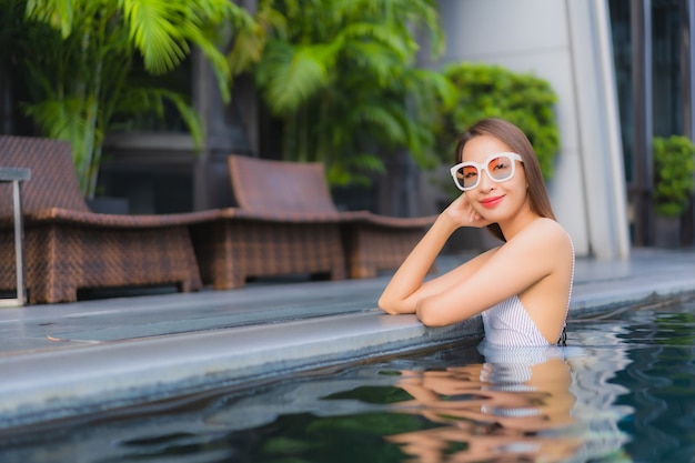 Portrait beautiful young asian woman relax smile leisure around outdoor swimming pool